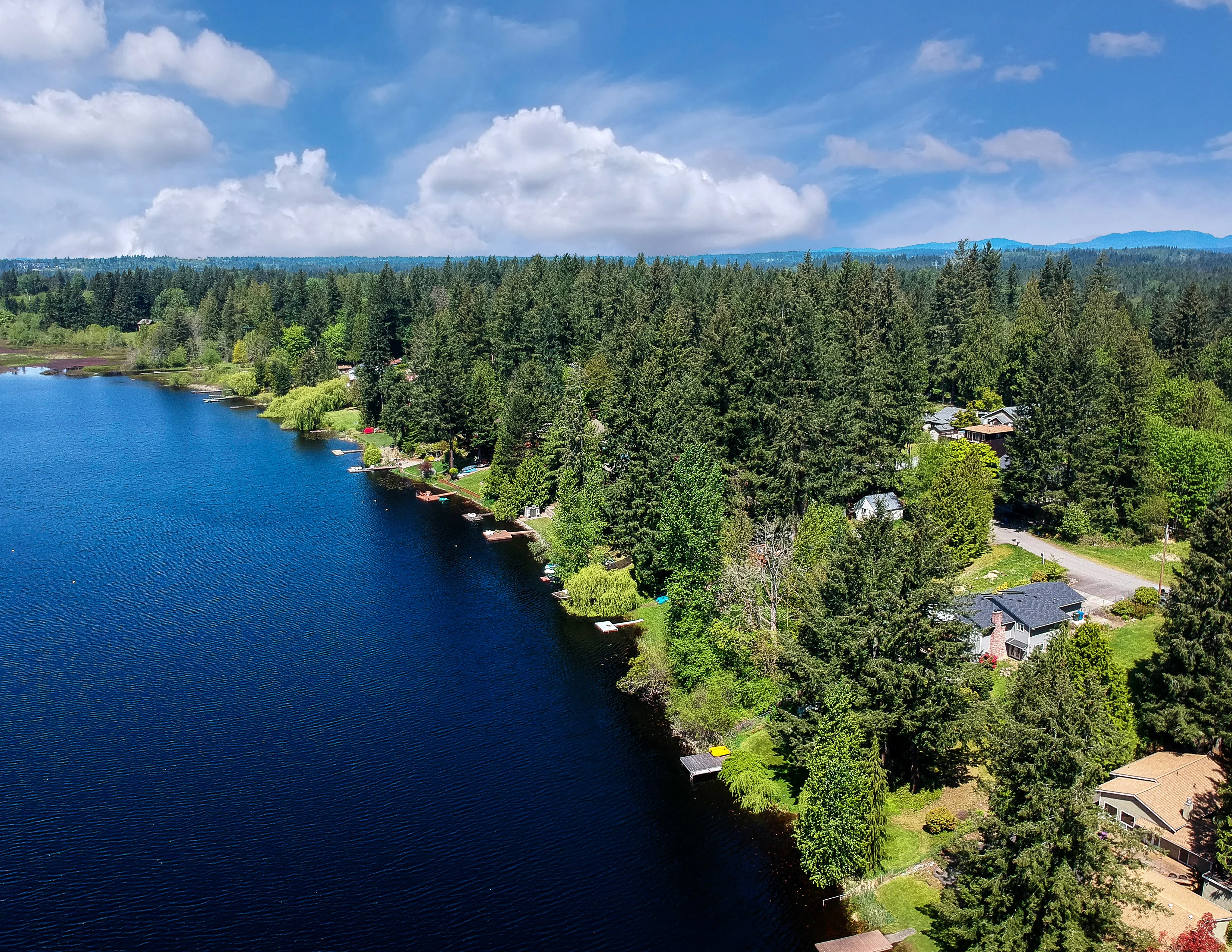 Lovely Lake Holm Water Access Site in Springtime with the Surrounding Forest and Homes and the Sky and Clouds in Auburn Washington | Motive